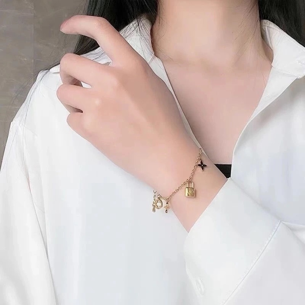 18K Gold Designer Charm Bracelet with Lock and Flower Accents - Picture 7 of 8
